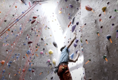 Male Climber Lets Go of Indoor Climbing Wall